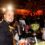 Bartender preparando drink em festa corporativa com bar completo