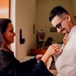 Assessora ajustando a lapela do noivo antes da cerimônia, assessoria e cerimonial de casamento em São Paulo